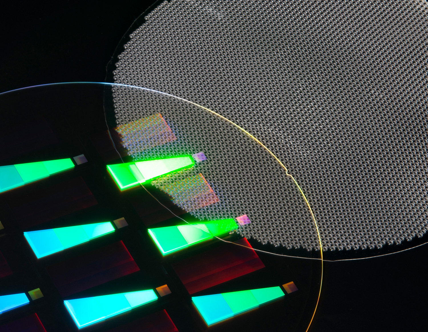 Two wafers, one featuring AR waveguide structures, using inkjet coating technology; the other wafer displays arrays of microlenses. Image by EV Group.